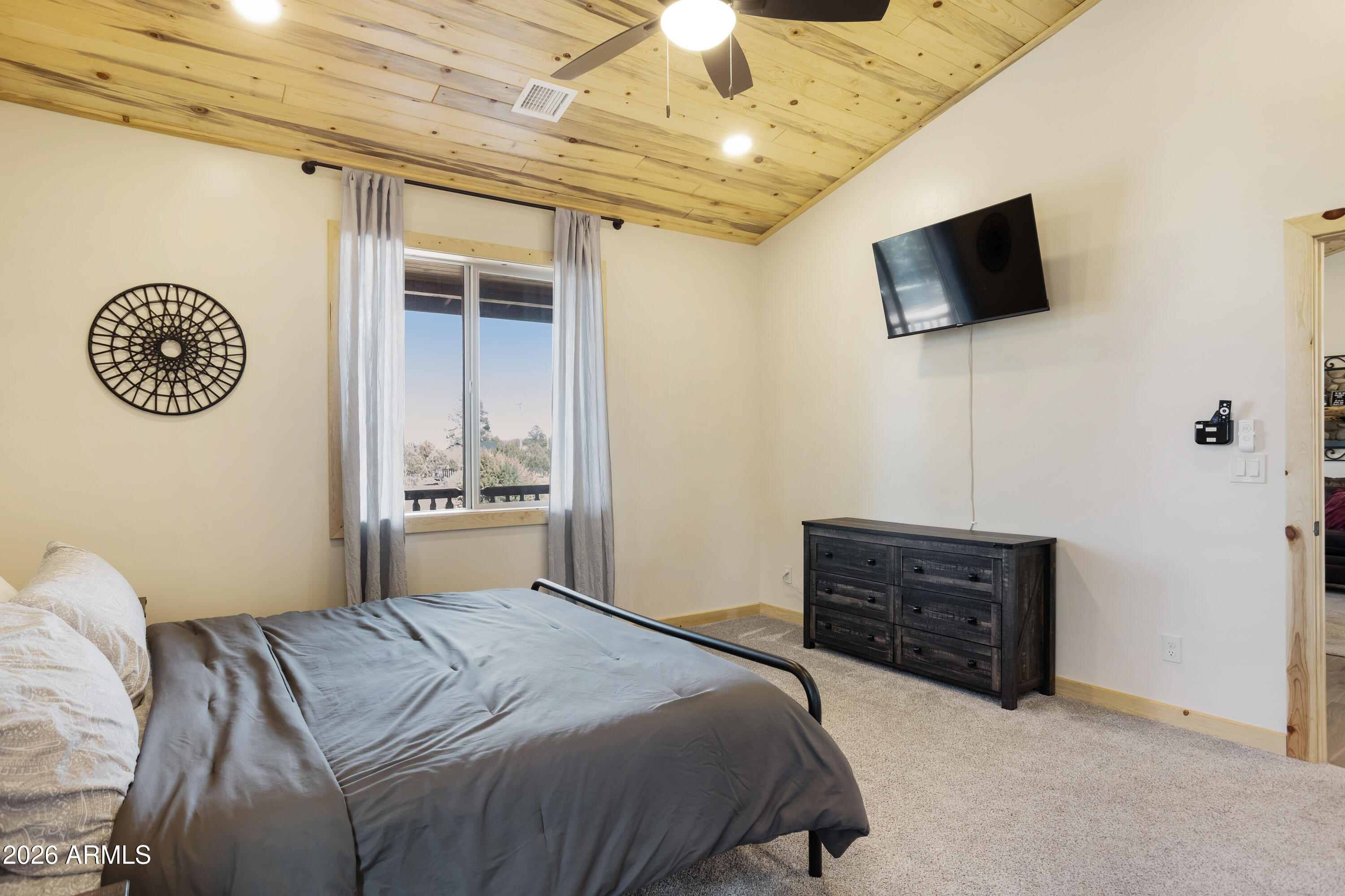 2718 Church Lane Overgaard, AZ 85933 - Photo 20 of 50 a bedroom with a bed and a flat screen tv