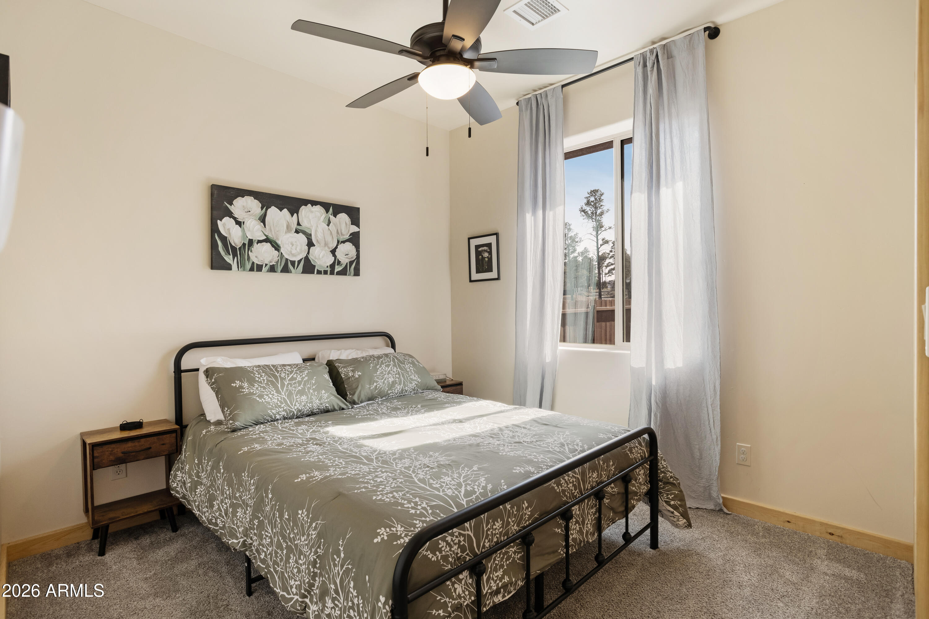 2718 Church Lane Overgaard, AZ 85933 - Photo 25 of 50 a bedroom with a bed and a chandelier