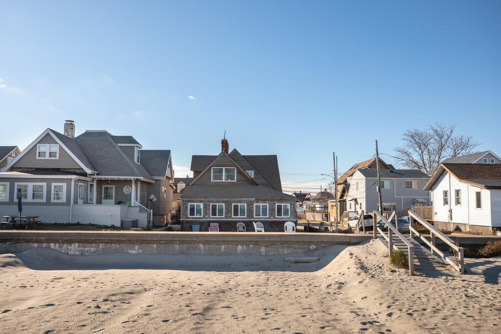 121 The Strand Winthrop, MA 02152 - Photo 11 of 13 a front view of a house with a yard