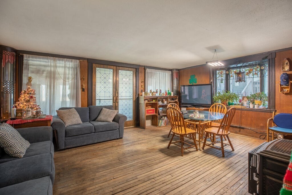 121 The Strand Winthrop, MA 02152 - Photo 6 of 13 a living room with furniture and a wooden floor