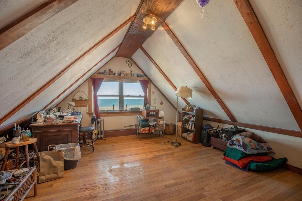 121 The Strand Winthrop, MA 02152 - Photo 8 of 13 a room with lots of white furniture and a wooden floor