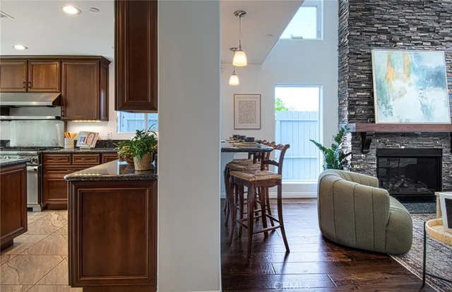 a kitchen with stainless steel appliances granite countertop a stove top oven a sink a counter space and cabinets