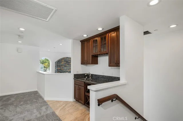 a kitchen with granite countertop a stove and a refrigerator