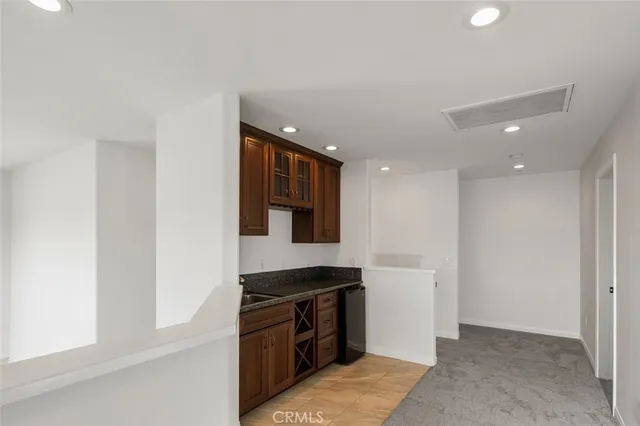 a kitchen with stainless steel appliances granite countertop a stove and a refrigerator
