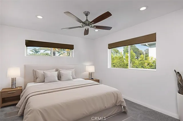 a bedroom with a large bed and a window