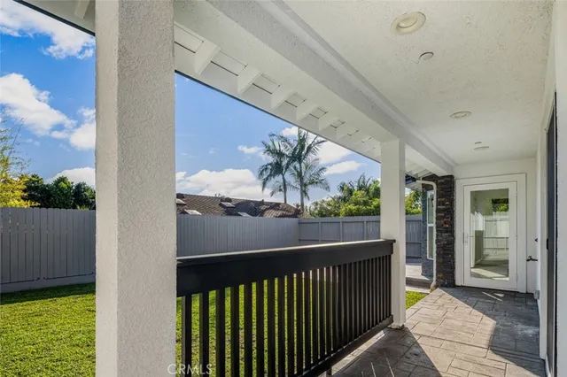 a front view of house along with deck and outdoor seating