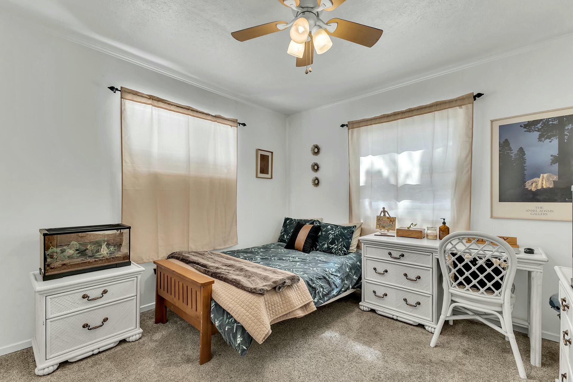52660 Sylvan Way Idyllwild, CA 92549 - Photo 17 of 25 a bedroom with a bed a dresser and painting on the wall