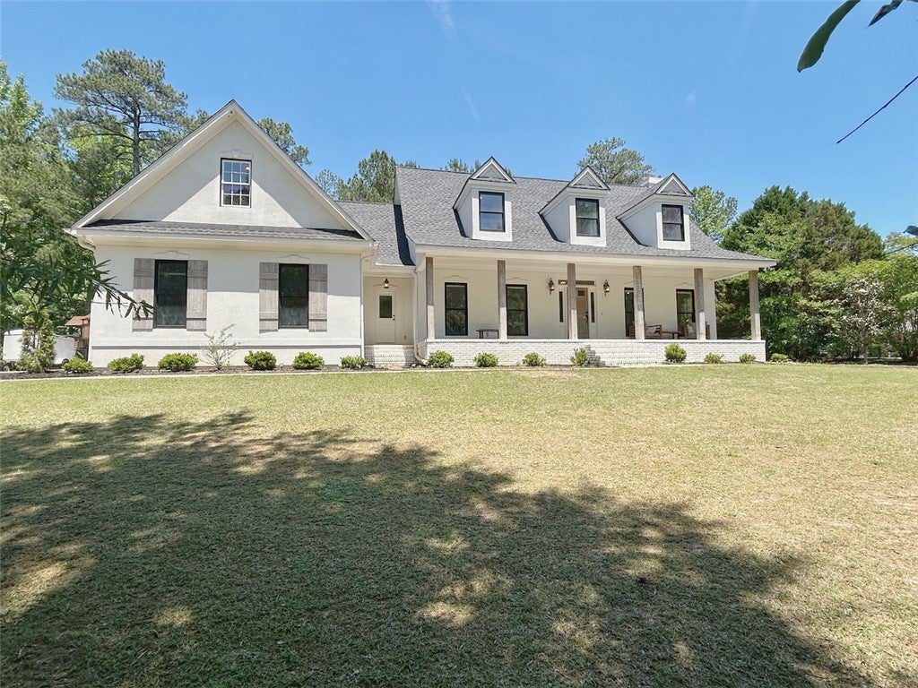 2004 Moores Mill Road Lanett, AL 36863 - Photo 4 of 50 This classic white residence features a welcoming porch, perfect for enjoying peaceful outdoor moments.