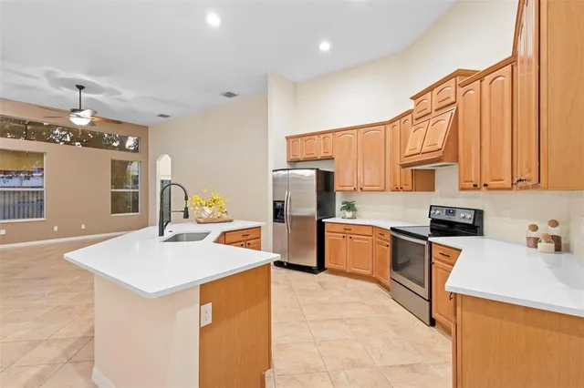 a kitchen with stainless steel appliances a sink stove and refrigerator