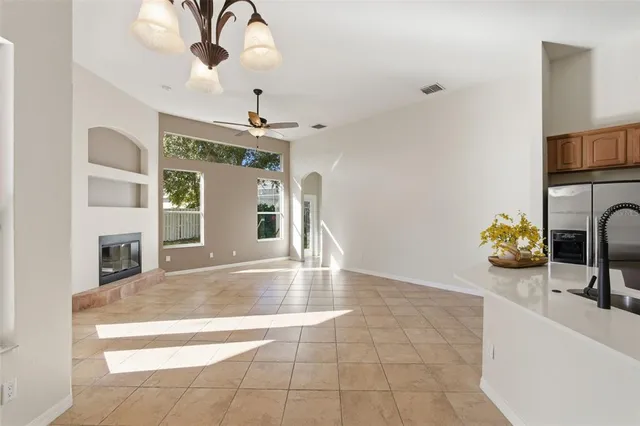 a view of an empty room with a fireplace and a window