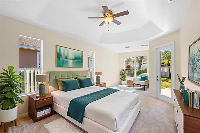 a bedroom with a balcony a bed and a chandelier