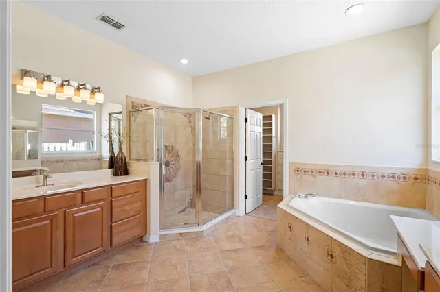 a view of an empty room with cabinet and window