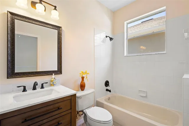 an empty room with closet and a window