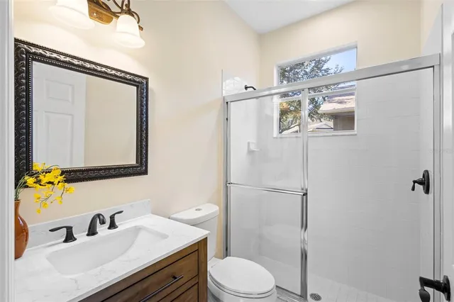 an empty room with chandelier fan