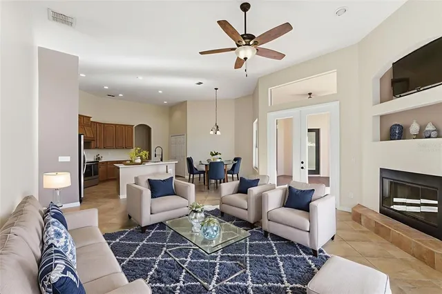 a living room with furniture a flat screen tv and a fireplace
