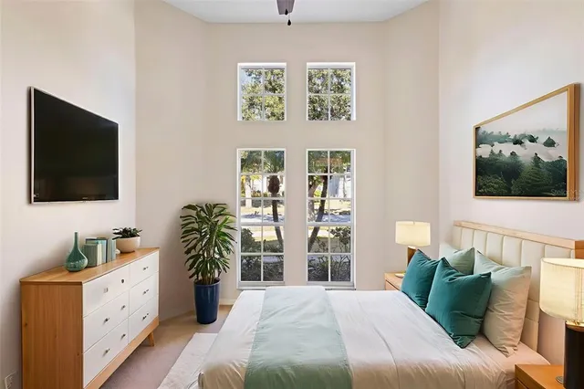 a bedroom with a large bed and a flat screen tv