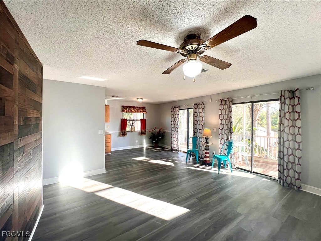 2002 Truman Avenue Alva, FL 33920 - Photo 11 of 30 a view of an empty room with wooden floor and a window