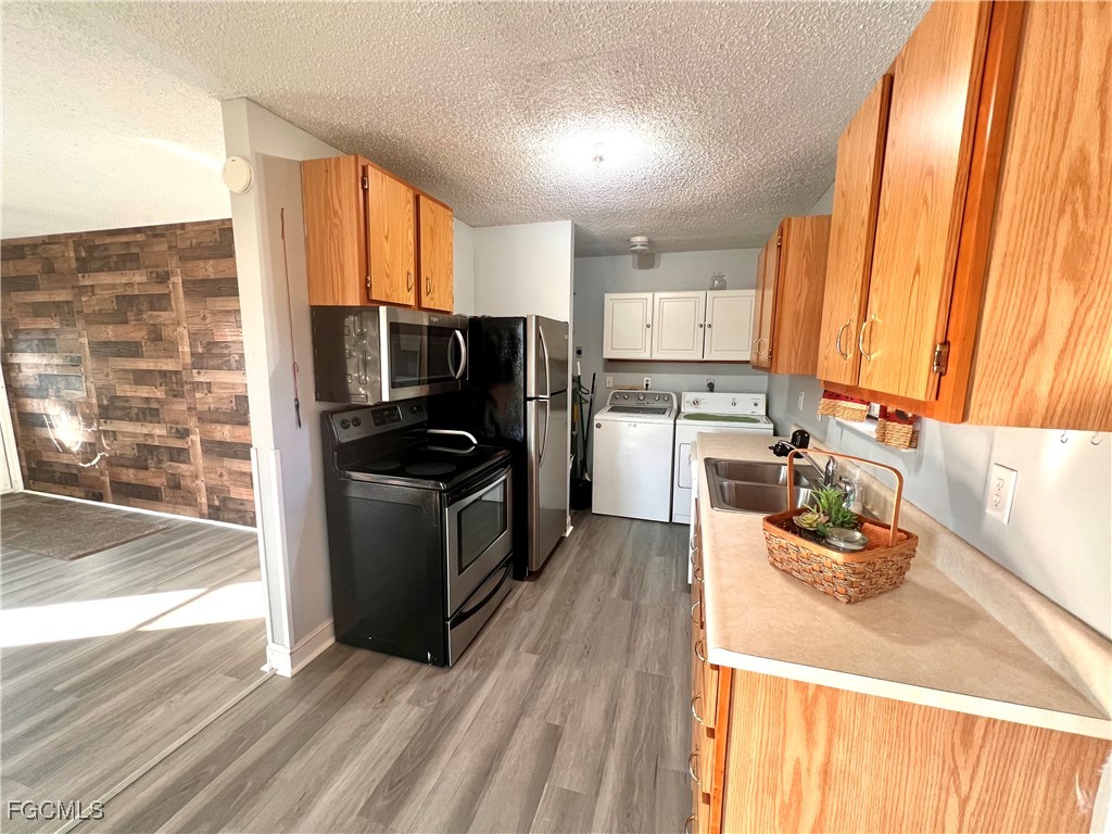 2002 Truman Avenue Alva, FL 33920 - Photo 14 of 30 a kitchen with stainless steel appliances a microwave a stove a sink and cabinets