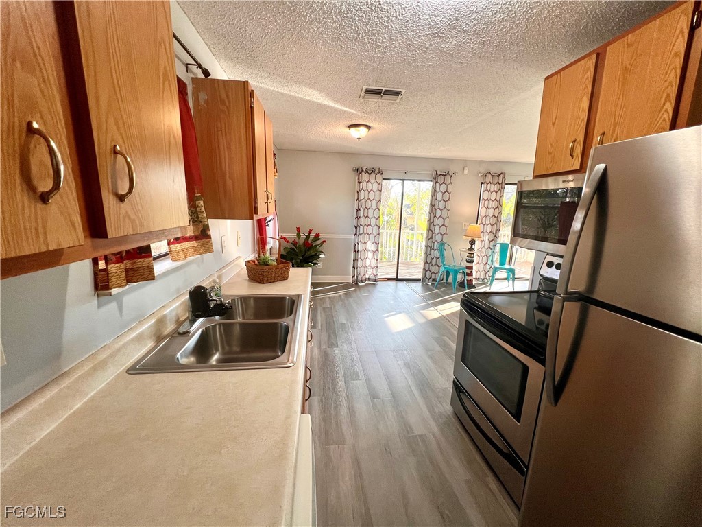 2002 Truman Avenue Alva, FL 33920 - Photo 15 of 30 a kitchen with sink refrigerator and large window