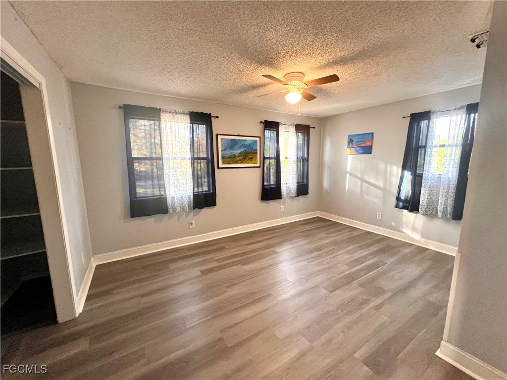 2002 Truman Avenue Alva, FL 33920 - Photo 20 of 30 an empty room with wooden floor and windows