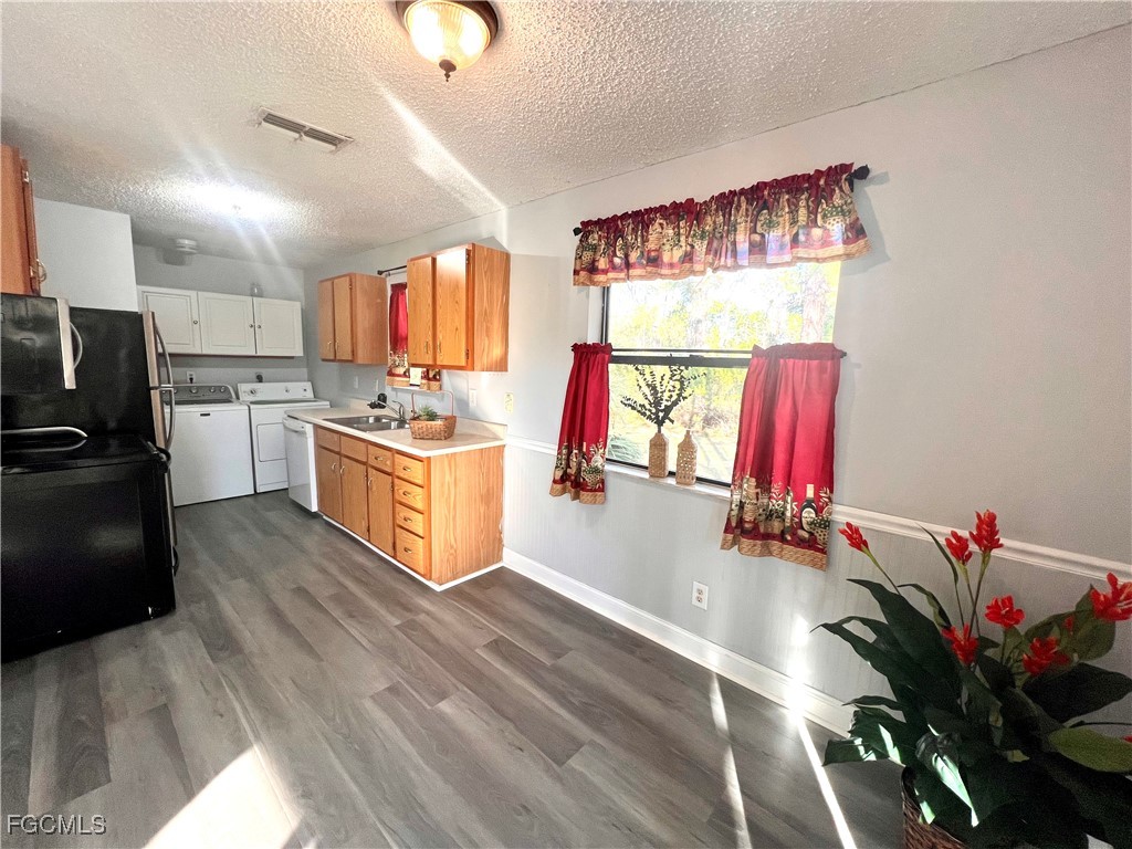 2002 Truman Avenue Alva, FL 33920 - Photo 24 of 30 a kitchen with stainless steel appliances granite countertop a refrigerator a stove and a wooden floors