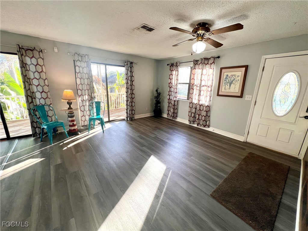 2002 Truman Avenue Alva, FL 33920 - Photo 8 of 30 a view of an empty room with wooden floor and a window