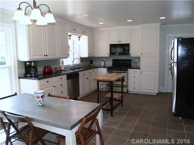 5320 Seacroft Road Charlotte, NC 28210 - Photo 3 of 12 a kitchen with kitchen island granite countertop a sink cabinets and stainless steel appliances