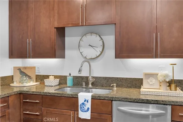 a kitchen with a stove sink and cabinets