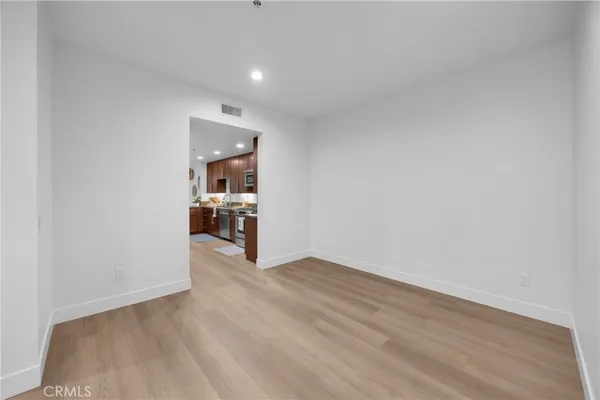 a kitchen with stainless steel appliances granite countertop a refrigerator a stove and a sink