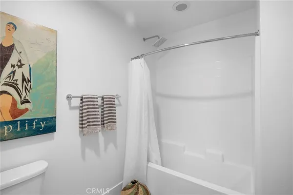 a bathroom with a granite countertop sink a mirror and shower