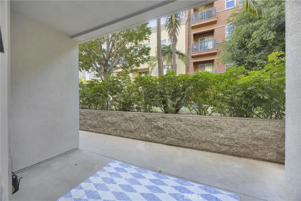 a view of a patio with couches and a fireplace
