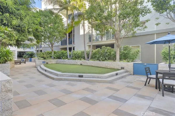 a view of backyard with swimming pool and outdoor seating