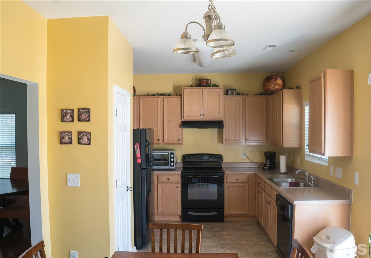 3716 Madeline Way Raleigh, NC 27610 - Photo 2 of 17 a kitchen with stainless steel appliances granite countertop a refrigerator a stove top oven a sink and dishwasher