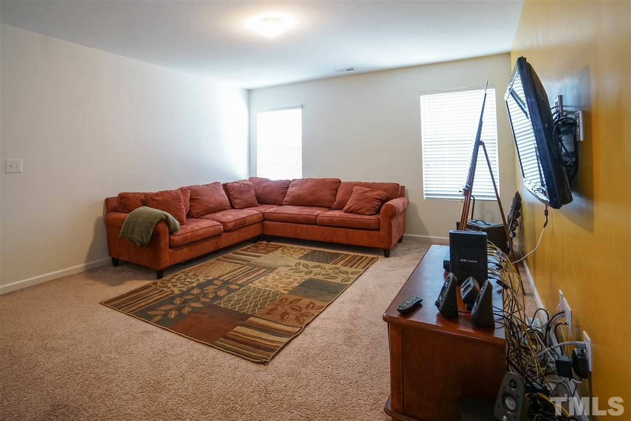 3716 Madeline Way Raleigh, NC 27610 - Photo 13 of 17 a living room with furniture and a rug