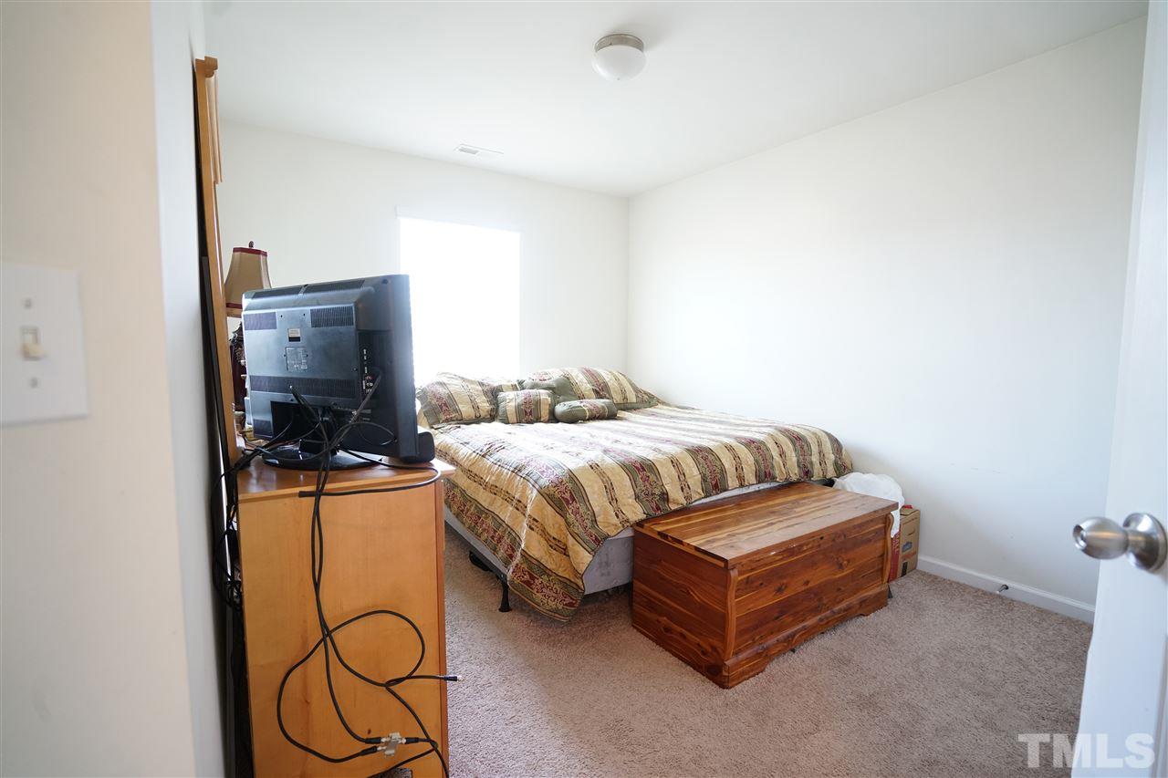 3716 Madeline Way Raleigh, NC 27610 - Photo 16 of 17 a bedroom with a bed and dresser