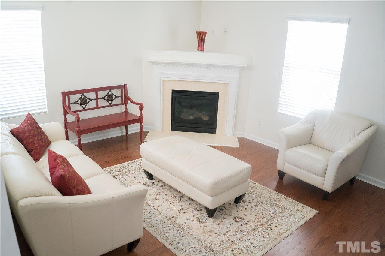 3716 Madeline Way Raleigh, NC 27610 - Photo 3 of 17 a living room with furniture and a fireplace