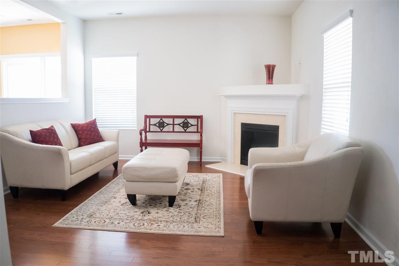 3716 Madeline Way Raleigh, NC 27610 - Photo 4 of 17 a living room with furniture and a fireplace