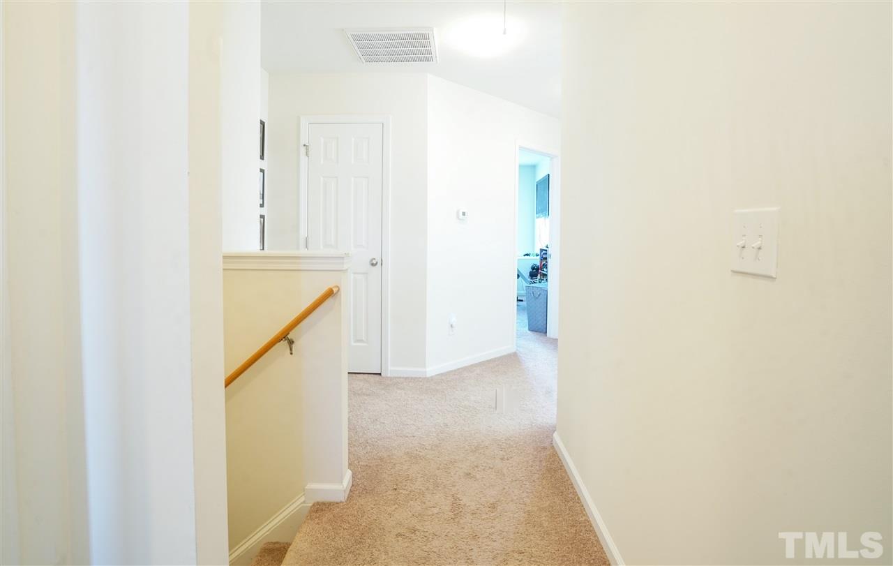 3716 Madeline Way Raleigh, NC 27610 - Photo 7 of 17 a view of a hallway with white walls