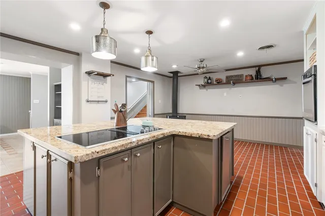a view of a room with lots of wooden furniture and windows