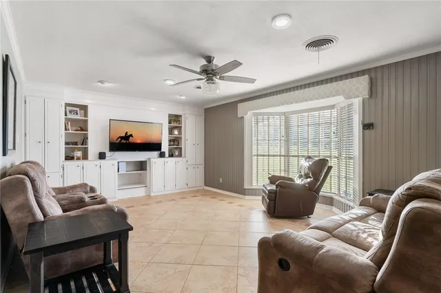 a spacious bedroom with a bed and ceiling fan