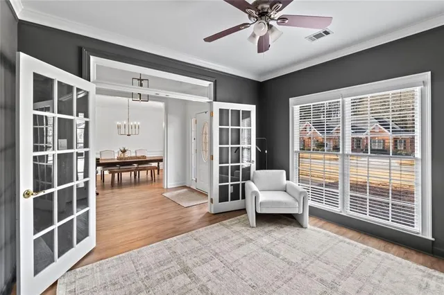 a living room with furniture and large windows