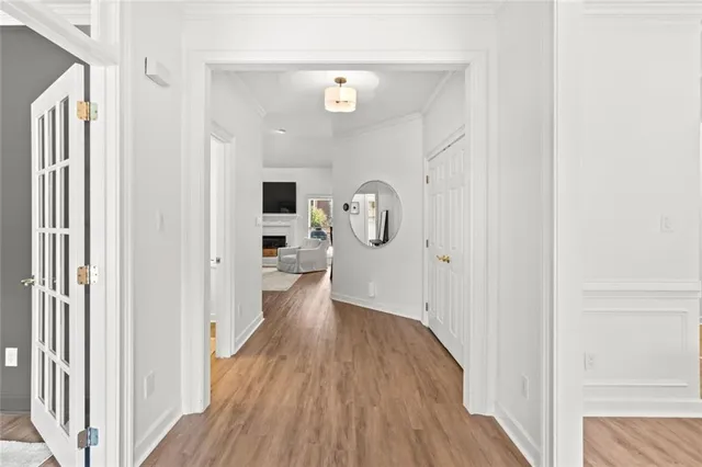 a view of a hallway with wooden floor