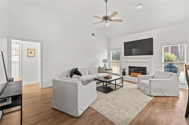 a living room with furniture a flat screen tv and a fireplace