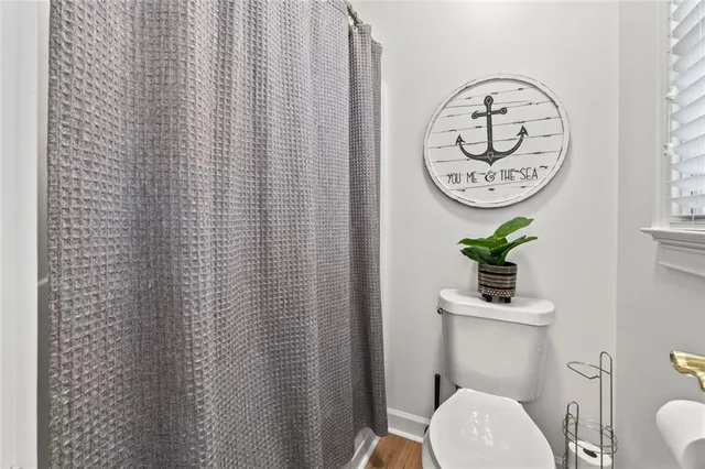 a view of a hallway with wooden floor and closet area