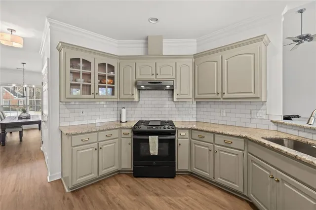 a kitchen with cabinets and stainless steel appliances