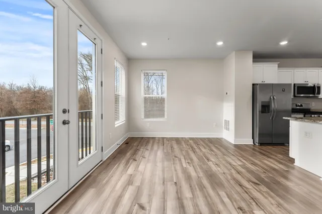 a view of a refrigerator in kitchen and wooden floor