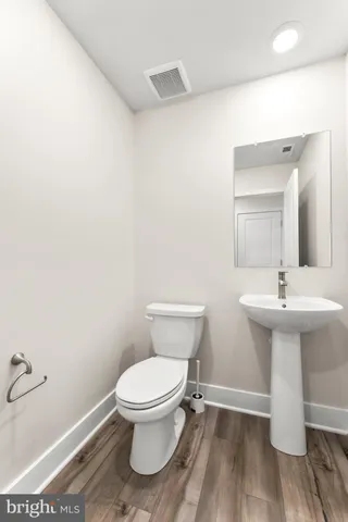 a bathroom with a sink toilet and a mirror