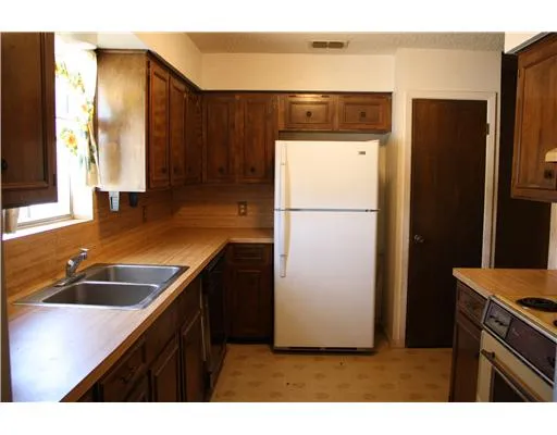 a kitchen with a refrigerator and a sink
