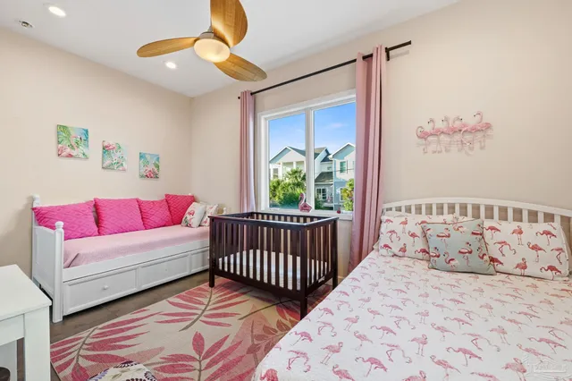 a bedroom with a bed a couch and a flat tv screen