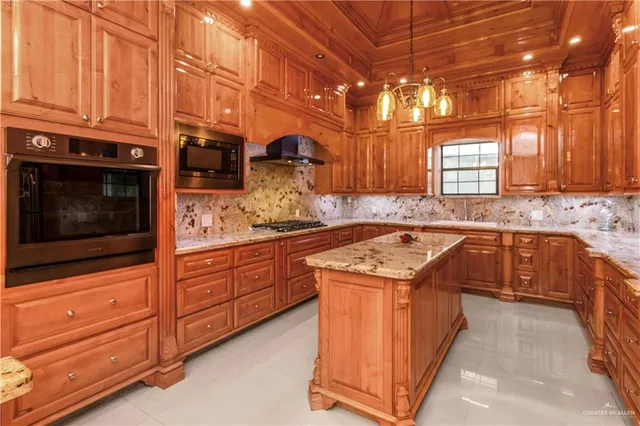 a kitchen with stainless steel appliances granite countertop wooden cabinets a sink and dishwasher